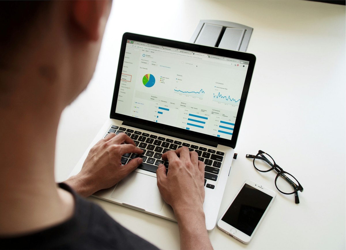 A person reviewing a laptop dashboard of charts and metrics to read a lead's signals